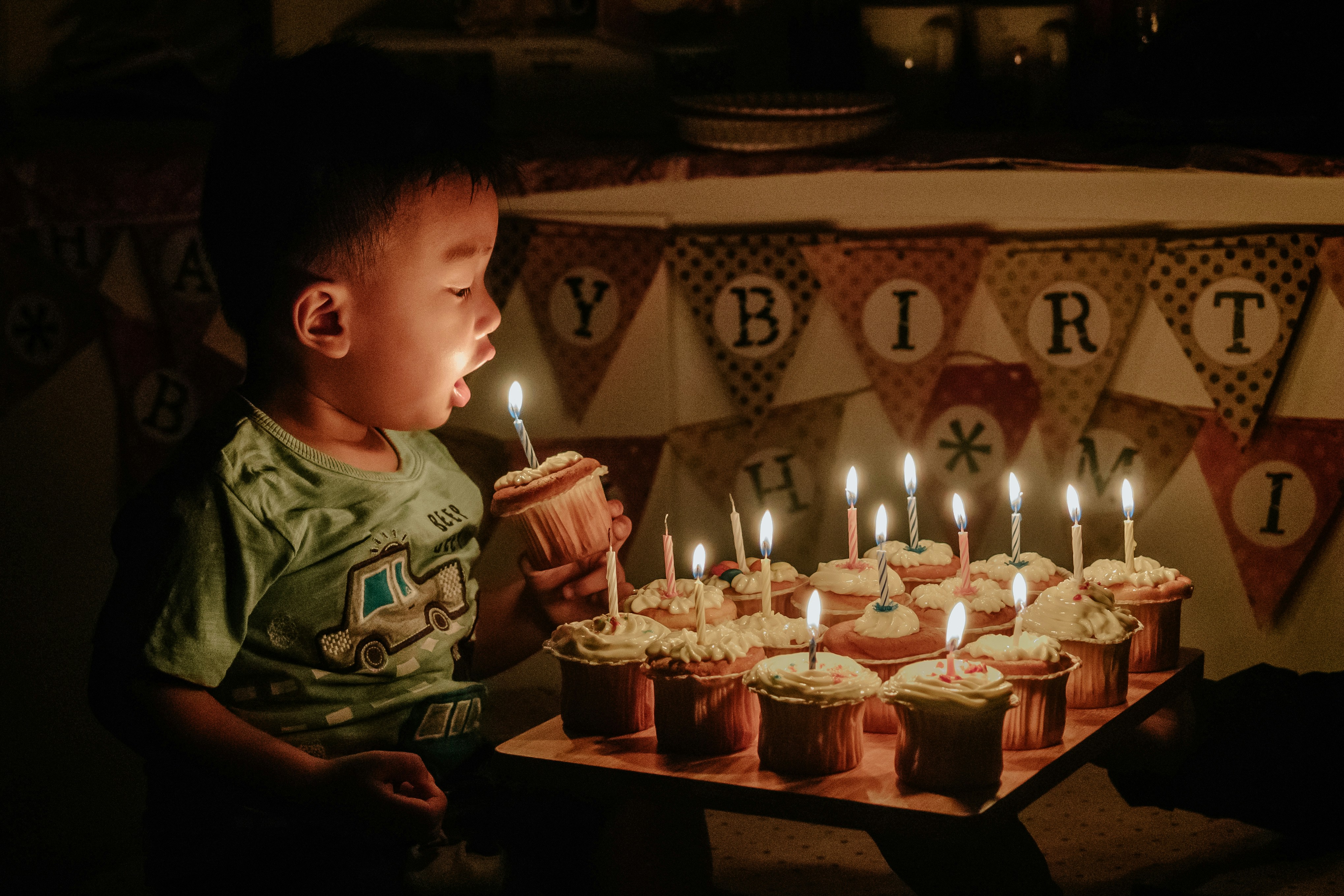 child blowing candle
